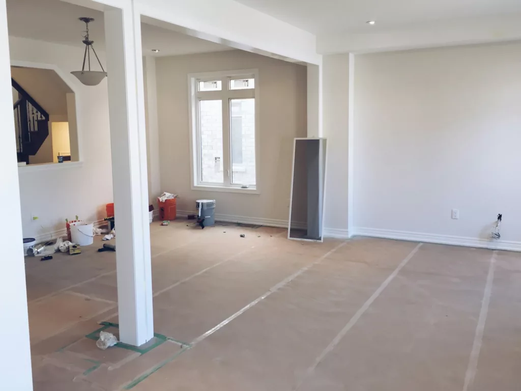Living room with covered flooring during home renovations